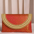 Maroon clutch bag named Twilight Gleam Foldover Clutch, featuring pearl detailing and soft fabric texture | Peora
