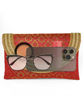 Maroon clutch bag named Twilight Gleam Foldover Clutch, featuring pearl detailing and soft fabric texture | Peora
