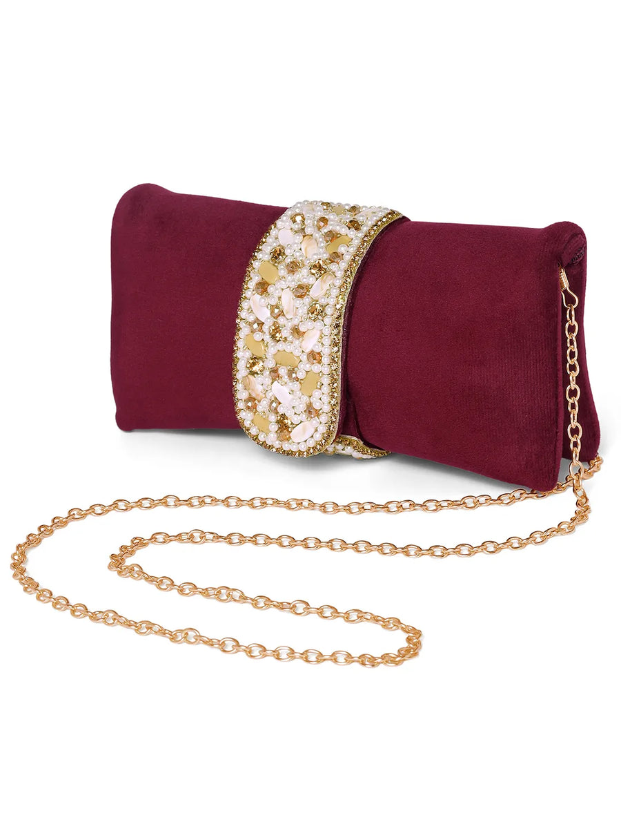 Maroon clutch bag named Clutch Bags Crafted for Elegance, featuring pearl detailing and soft fabric texture | Peora

