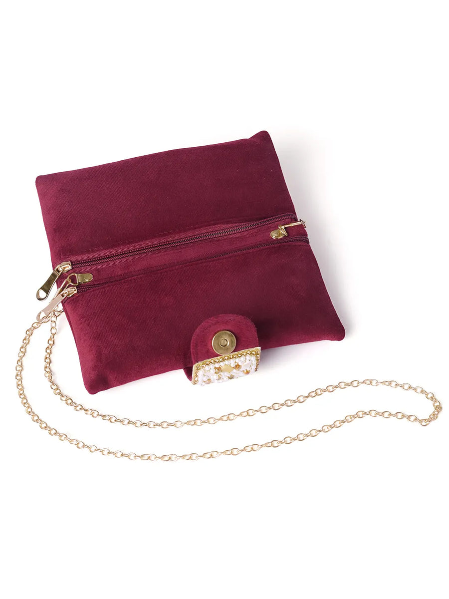Maroon clutch bag named Clutch Bags Crafted for Elegance, featuring pearl detailing and soft fabric texture | Peora
