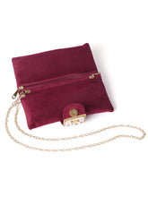 Maroon clutch bag named Clutch Bags Crafted for Elegance, featuring pearl detailing and soft fabric texture | Peora

