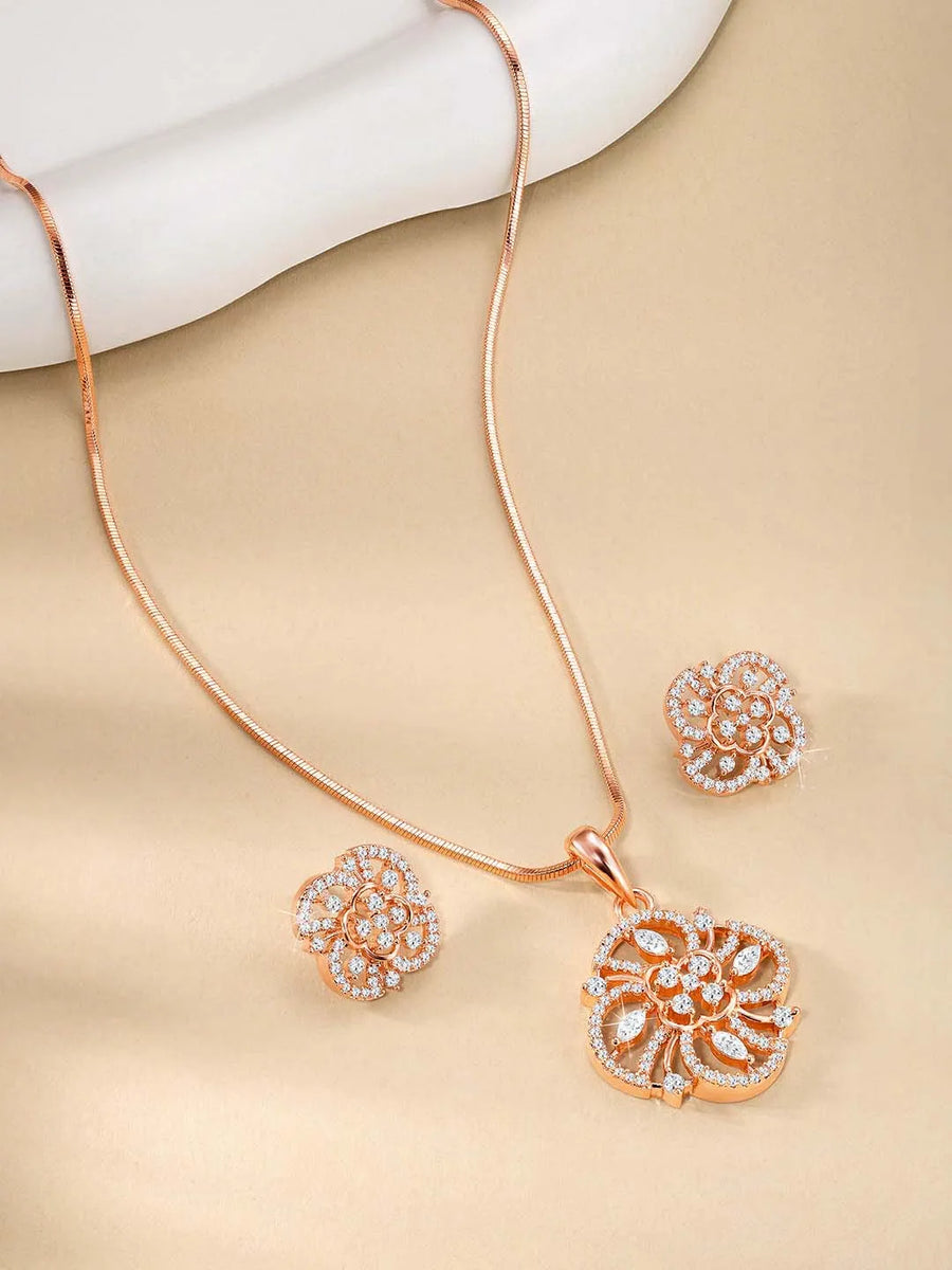 Contemporary Floral CZ Pendant Set by Peora. Rose gold-plated pendant set in floral shape with CZ stones & earrings.