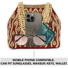 Maroon potli bag named Embroidered Beaded Potli Purse, featuring faux pearl detailing and soft fabric texture | Peora
