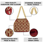 Maroon potli bag named Embroidered Beaded Potli Purse, featuring faux pearl detailing and soft fabric texture | Peora
