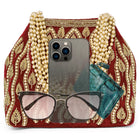 Maroon potli bag named Embroidered Beaded Potli Purse, featuring faux pearl detailing and soft fabric texture | Peora
