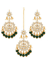 Majestic Glow Earring and Maangtikka. Pair of earrings & Maangtikka, with gold plating, kundan, green beads along with pearls. Buy best selling jewellery from Peora.