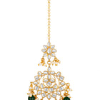 Majestic Glow Earring and Maangtikka. Pair of earrings & Maangtikka, with gold plating, kundan, green beads along with pearls. Buy best selling jewellery from Peora.