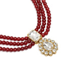 Graceful Layers with Kundan Set. Gold-plated red beaded necklace set with large white stones and matching drop earrings.