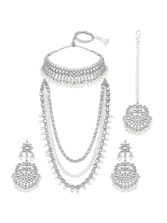 Bridal Splendour Kundan Pearls Set. Silver-plated layered bridal necklace set with pearls, kundan and matching earrings, complemented by a maang tikka.
