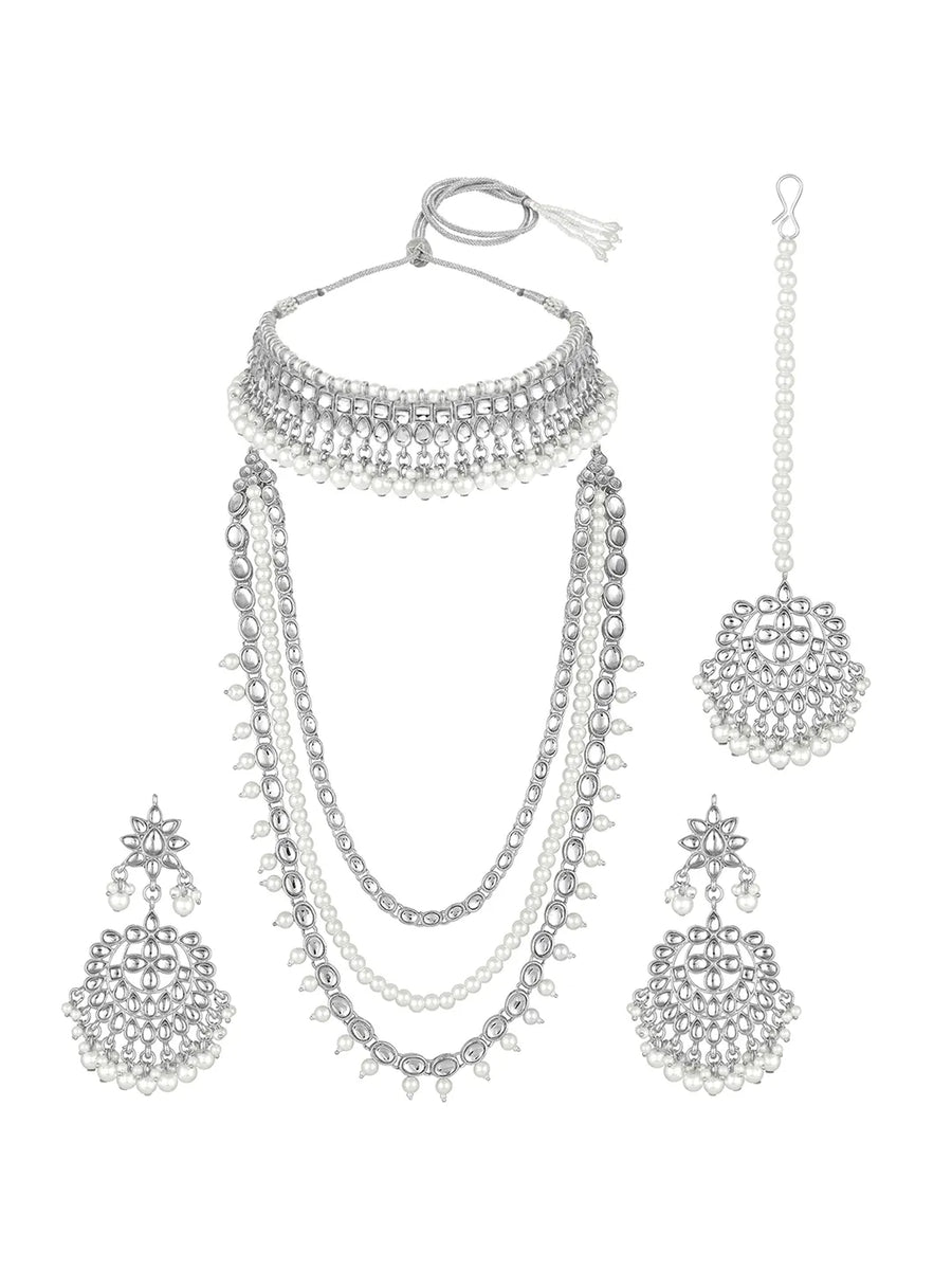 Bridal Splendour Kundan Pearls Set. Silver-plated layered bridal necklace set with pearls, kundan and matching earrings, complemented by a maang tikka.