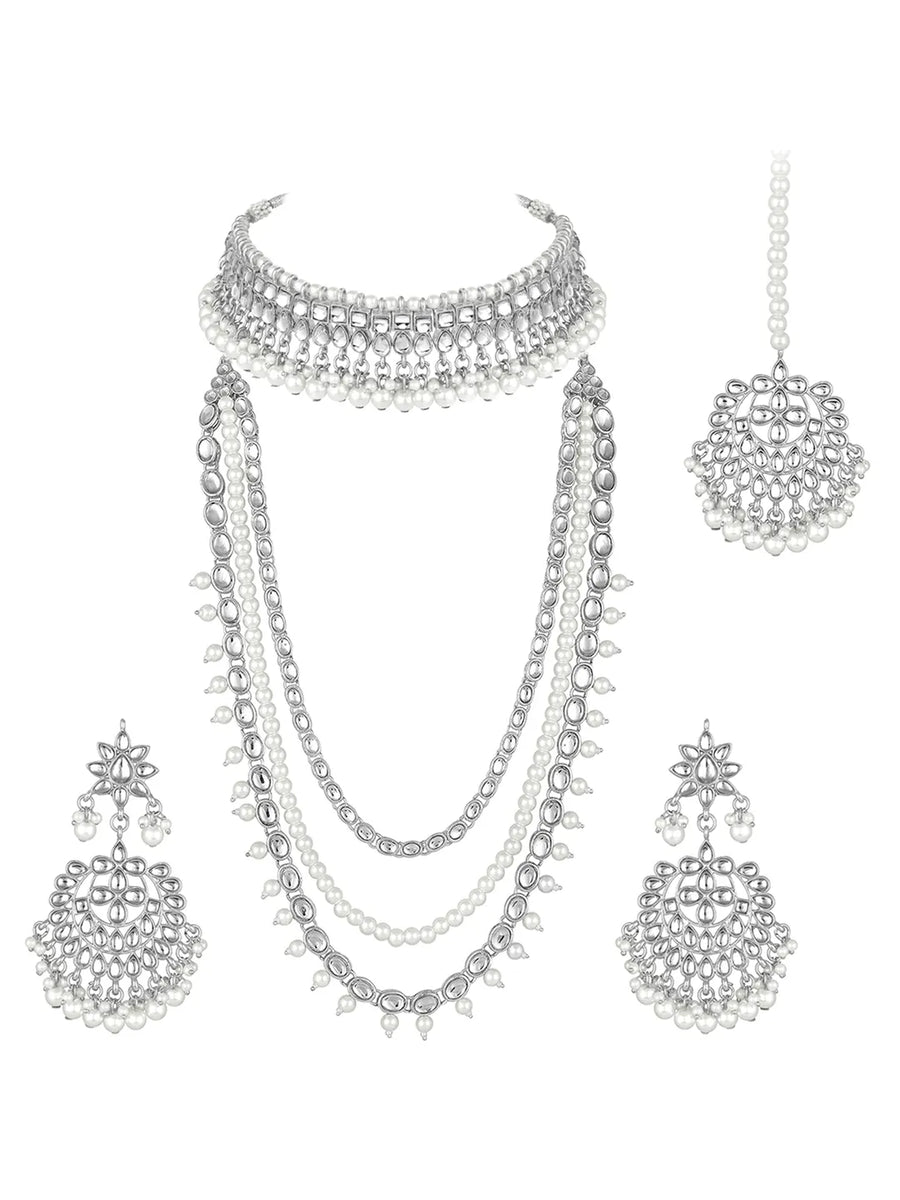 Bridal Splendour Kundan Pearls Set. Silver-plated layered bridal necklace set with pearls, kundan and matching earrings, complemented by a maang tikka.