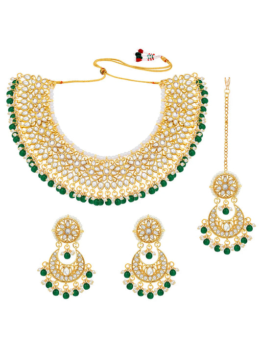 Divine Grace Kundan Bridal Set. Gold and green Kundan necklace set with pearls, matching earrings, and maang tikka.
