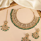 Divine Grace Kundan Bridal Set. Gold and green Kundan necklace set with pearls, matching earrings, and maang tikka.