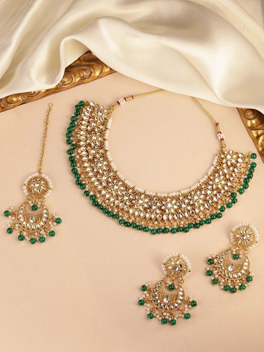 Divine Grace Kundan Bridal Set. Gold and green Kundan necklace set with pearls, matching earrings, and maang tikka.