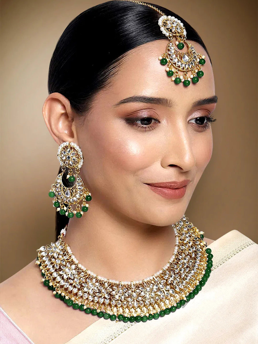 Divine Grace Kundan Bridal Set. Gold and green Kundan necklace set with pearls, matching earrings, and maang tikka.