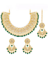 Divine Grace Kundan Bridal Set. Gold and green Kundan necklace set with pearls, matching earrings, and maang tikka.