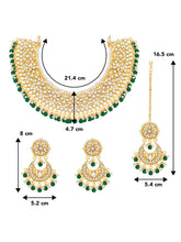 Divine Grace Kundan Bridal Set. Gold and green Kundan necklace set with pearls, matching earrings, and maang tikka.