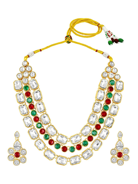 Crystal Studded Layered Necklace Set. Gold-plated Kundan necklace set with green, red and white stones, paired with matching earrings.