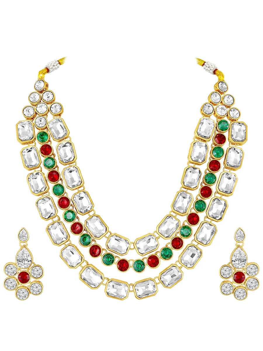 Crystal Studded Layered Necklace Set. Gold-plated Kundan necklace set with green, red and white stones, paired with matching earrings.