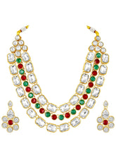 Crystal Studded Layered Necklace Set. Gold-plated Kundan necklace set with green, red and white stones, paired with matching earrings.