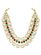 Crystal Studded Layered Necklace Set. Gold-plated Kundan necklace set with green, red and white stones, paired with matching earrings.