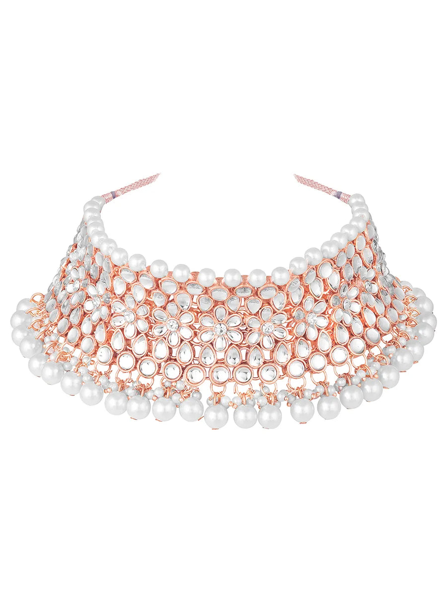 Radiance Faux Kundan Choker Set. Rose gold choker necklace set with white pearls and kundan, paired with matching floral jhumka earrings.