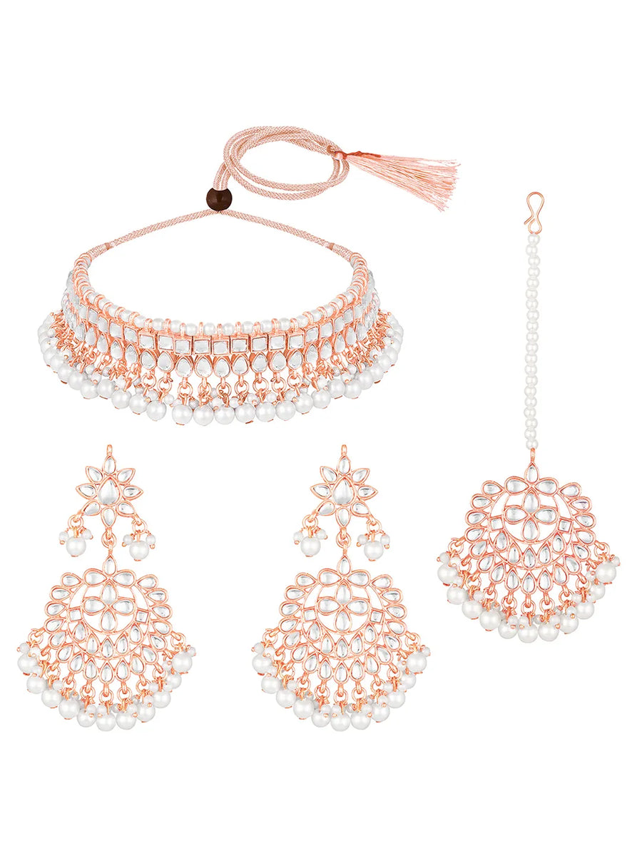 Marvel Kundan Pearls Choker Set. Rose gold choker necklace set with pearls and kundan, paired with matching earrings and maang tikka.
