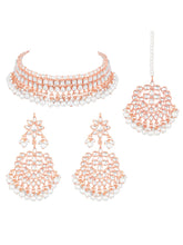 Marvel Kundan Pearls Choker Set. Rose gold choker necklace set with pearls and kundan, paired with matching earrings and maang tikka.