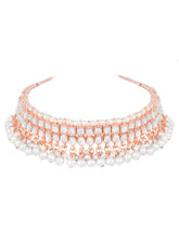 Marvel Kundan Pearls Choker Set. Rose gold choker necklace set with pearls and kundan, paired with matching earrings and maang tikka.