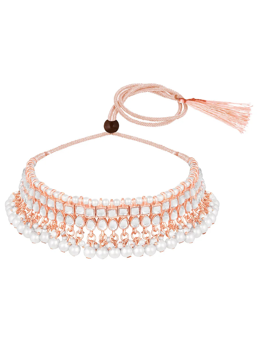 Marvel Kundan Pearls Choker Set. Rose gold choker necklace set with pearls and kundan, paired with matching earrings and maang tikka.