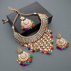 Bridal Bliss Kundan Pearl Necklace Set. Gold-plated Kundan bridal necklace set with colorful beads, matching jhumka earrings, and maang tikka. Perfect for weddings and festive occasions.