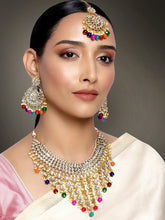 Bridal Bliss Kundan Pearl Necklace Set. Gold-plated Kundan bridal necklace set with colorful beads, matching jhumka earrings, and maang tikka. Perfect for weddings and festive occasions.