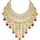 Bridal Bliss Kundan Pearl Necklace Set. Gold-plated Kundan bridal necklace set with colorful beads, matching jhumka earrings, and maang tikka. Perfect for weddings and festive occasions.