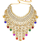Bridal Bliss Kundan Pearl Necklace Set. Gold-plated Kundan bridal necklace set with colorful beads, matching jhumka earrings, and maang tikka. Perfect for weddings and festive occasions.