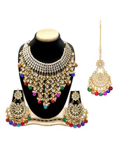 Bridal Bliss Kundan Pearl Necklace Set. Gold-plated Kundan bridal necklace set with colorful beads, matching jhumka earrings, and maang tikka. Perfect for weddings and festive occasions.