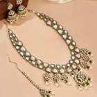 Bridal Bliss Kundan Pearl Adorn. Gold and green Kundan bridal necklace set with pearls, matching earrings, and maang tikka. Perfect for weddings and festive wear.