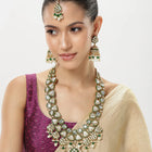 Bridal Bliss Kundan Pearl Adorn. Gold and green Kundan bridal necklace set with pearls, matching earrings, and maang tikka. Perfect for weddings and festive wear.