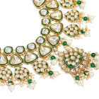 Bridal Bliss Kundan Pearl Adorn. Gold and green Kundan bridal necklace set with pearls, matching earrings, and maang tikka. Perfect for weddings and festive wear.