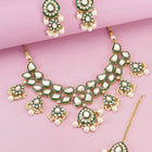 Pearled Petals Kundan Wedding Set. Gold and green Kundan necklace set with pearls, matching earrings, and maang tikka ideal for festive and traditional wear.