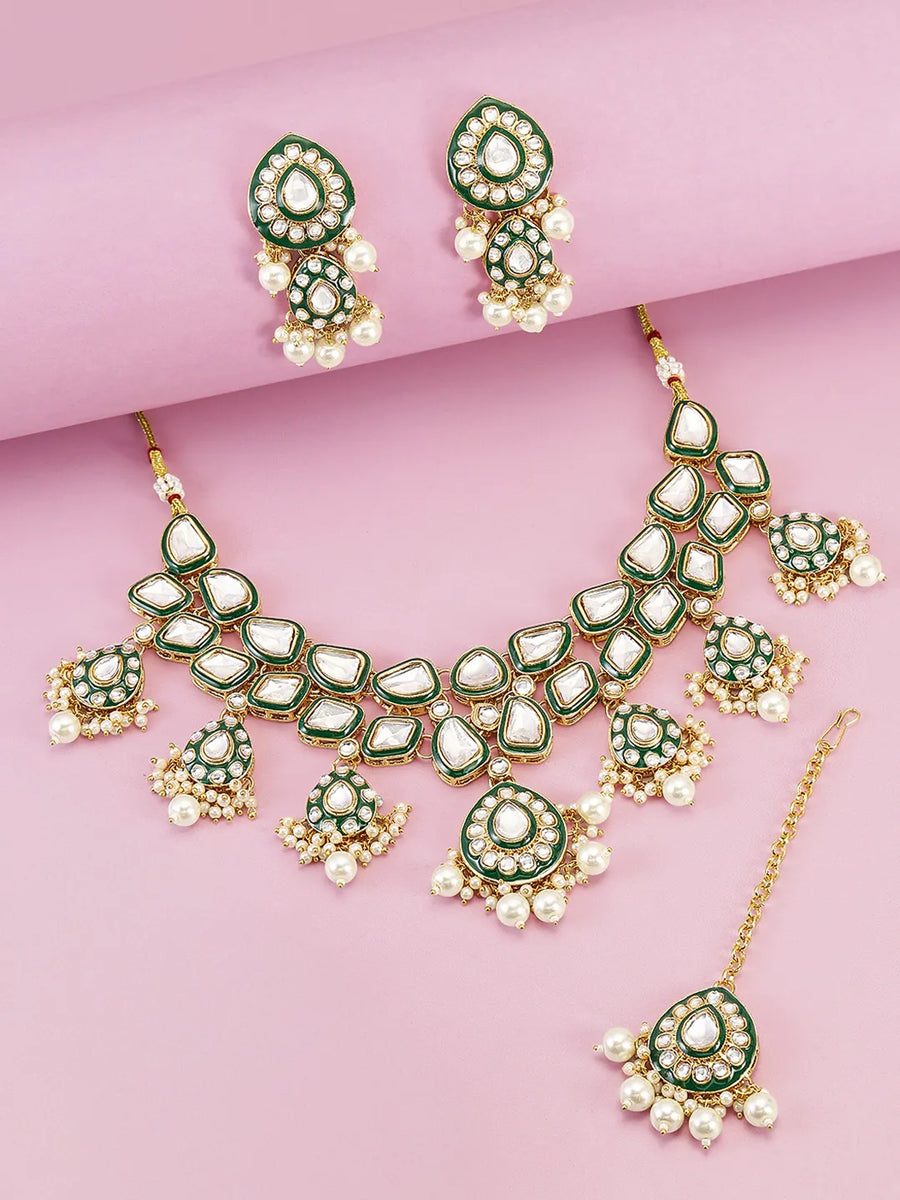 Pearled Petals Kundan Wedding Set. Gold and green Kundan necklace set with pearls, matching earrings, and maang tikka ideal for festive and traditional wear.