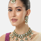 Pearled Petals Kundan Wedding Set. Gold and green Kundan necklace set with pearls, matching earrings, and maang tikka ideal for festive and traditional wear.