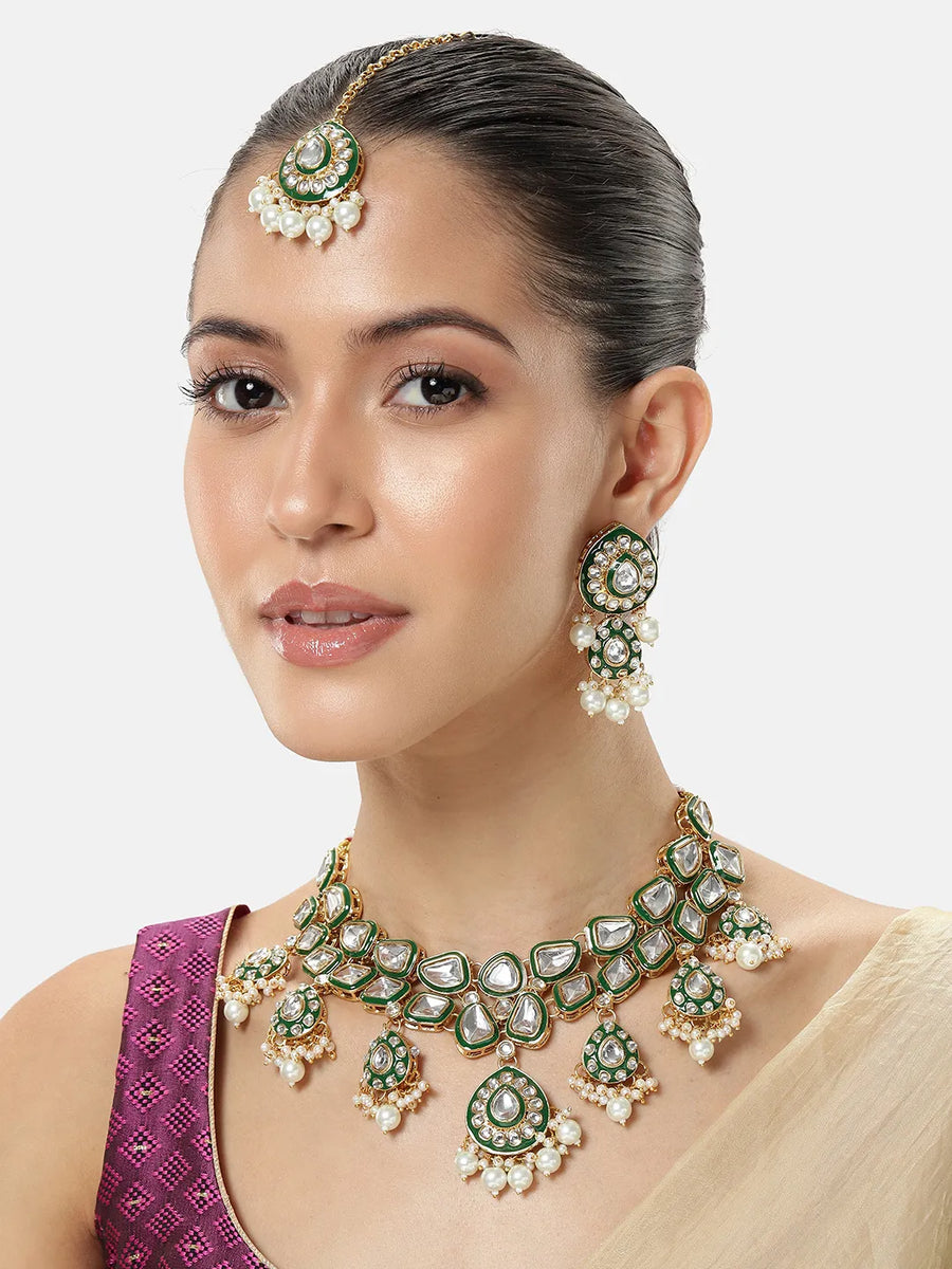 Pearled Petals Kundan Wedding Set. Gold and green Kundan necklace set with pearls, matching earrings, and maang tikka ideal for festive and traditional wear.