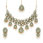 Pearled Petals Kundan Wedding Set. Gold and green Kundan necklace set with pearls, matching earrings, and maang tikka ideal for festive and traditional wear.