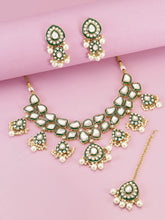 Pearled Petals Kundan Wedding Set. Gold and green Kundan necklace set with pearls, matching earrings, and maang tikka ideal for festive and traditional wear.