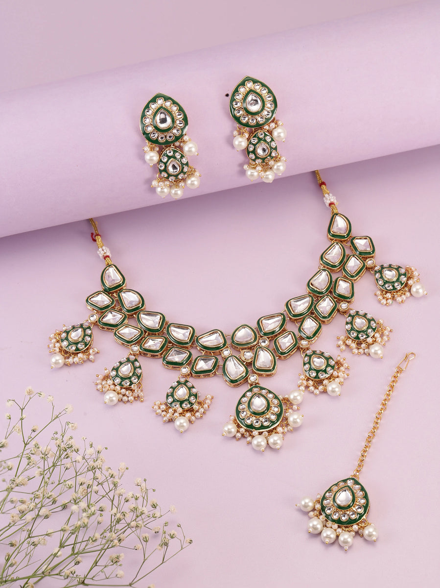 Pearled Petals Kundan Wedding Set. Gold and green Kundan necklace set with pearls, matching earrings, and maang tikka ideal for festive and traditional wear.