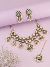Pearled Petals Kundan Wedding Set. Gold and green Kundan necklace set with pearls, matching earrings, and maang tikka ideal for festive and traditional wear.