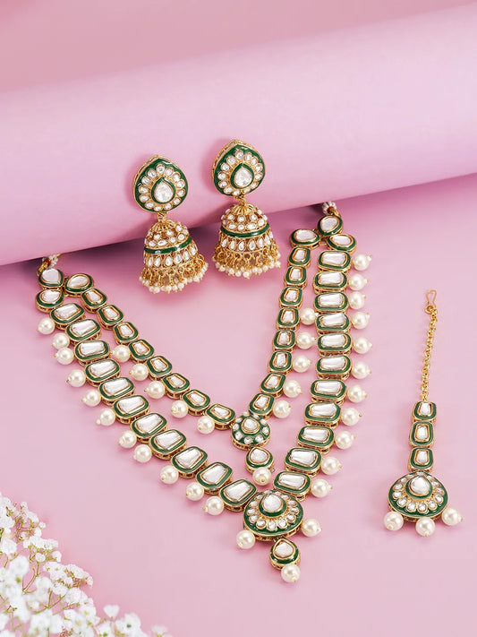 Kundan Majesty Double Layer Set. Gold and green double-layer Kundan necklace set with pearls, matching jhumka earrings, and maang tikka – perfect for festive and traditional wear.