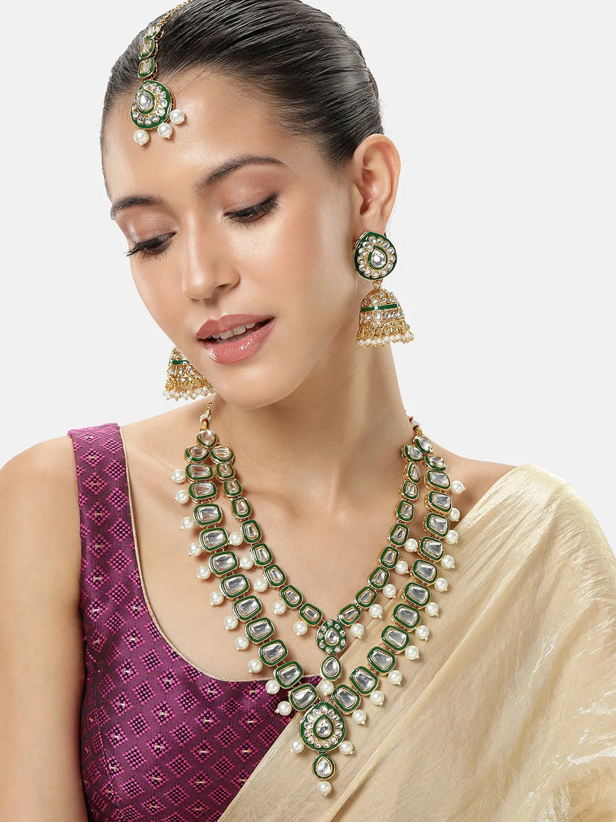Kundan Majesty Double Layer Set. Gold and green double-layer Kundan necklace set with pearls, matching jhumka earrings, and maang tikka – perfect for festive and traditional wear.