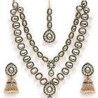 Kundan Majesty Double Layer Set. Gold and green double-layer Kundan necklace set with pearls, matching jhumka earrings, and maang tikka – perfect for festive and traditional wear.