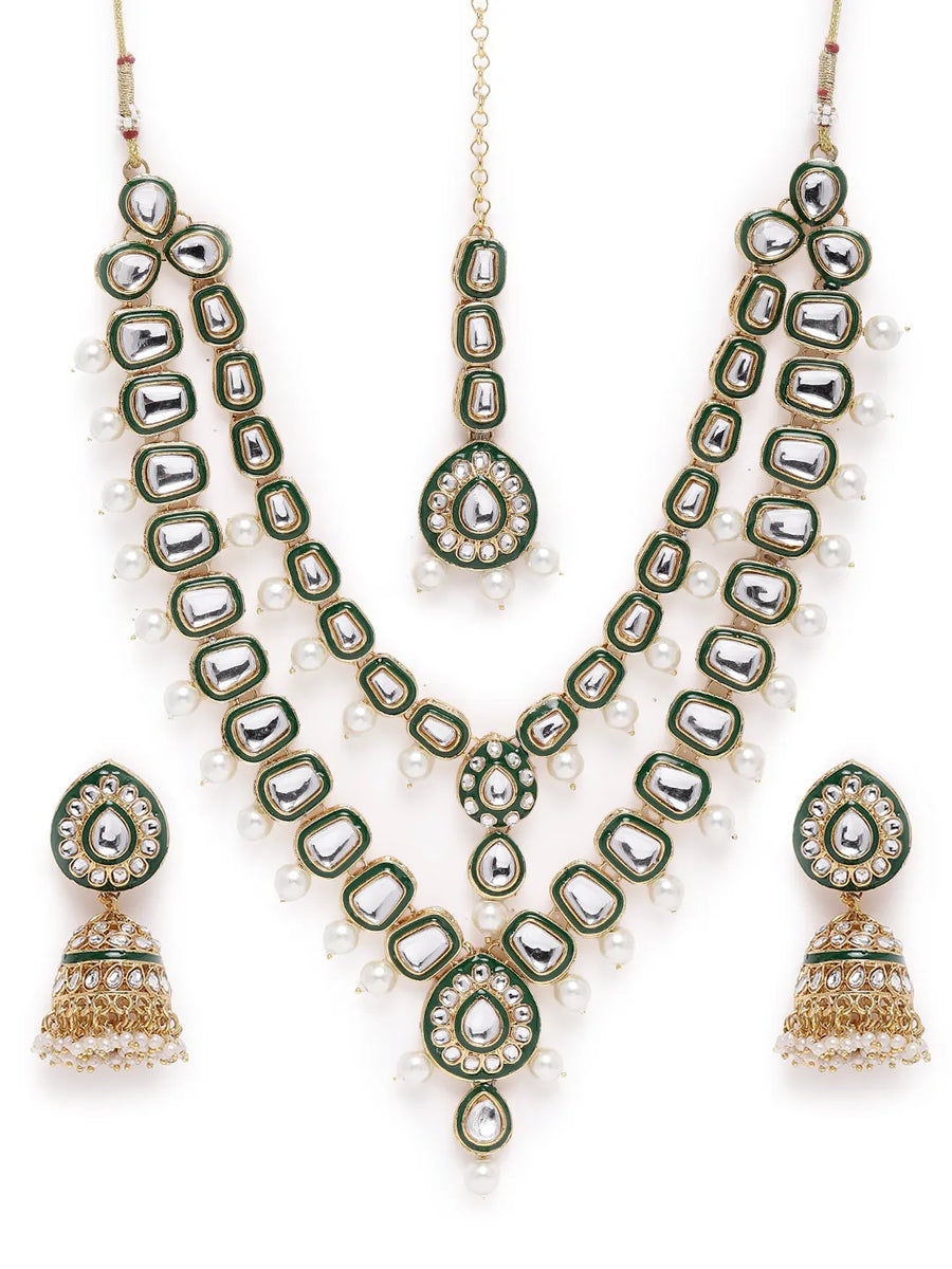 Kundan Majesty Double Layer Set. Gold and green double-layer Kundan necklace set with pearls, matching jhumka earrings, and maang tikka – perfect for festive and traditional wear.